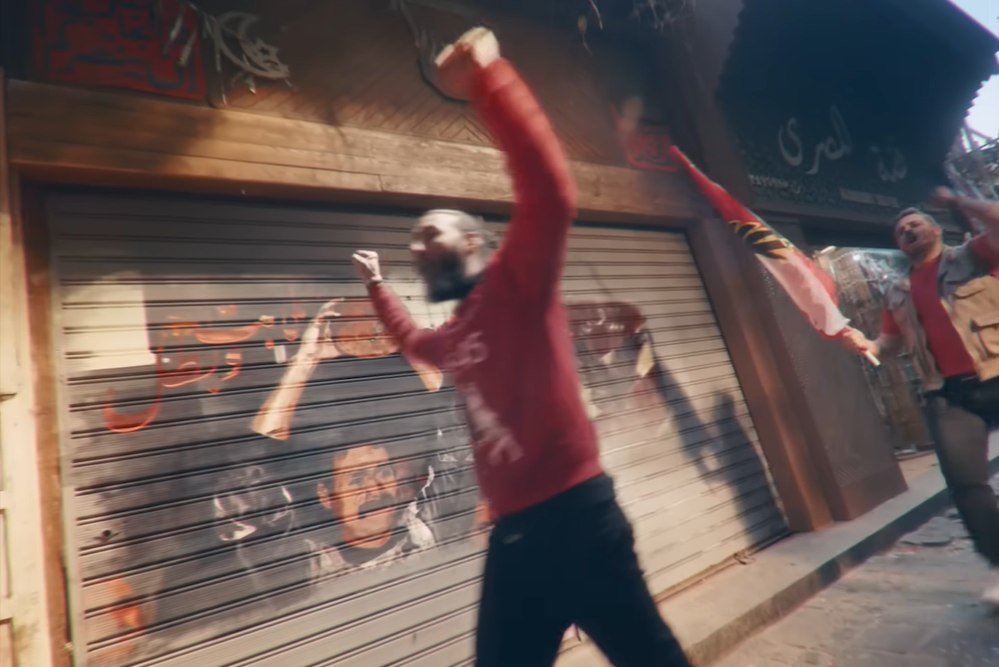 Final film frame — a fan raising an Al Ahly scarf