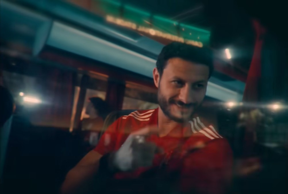 Final film frame — a smiling supporter in an Al Ahly jacket