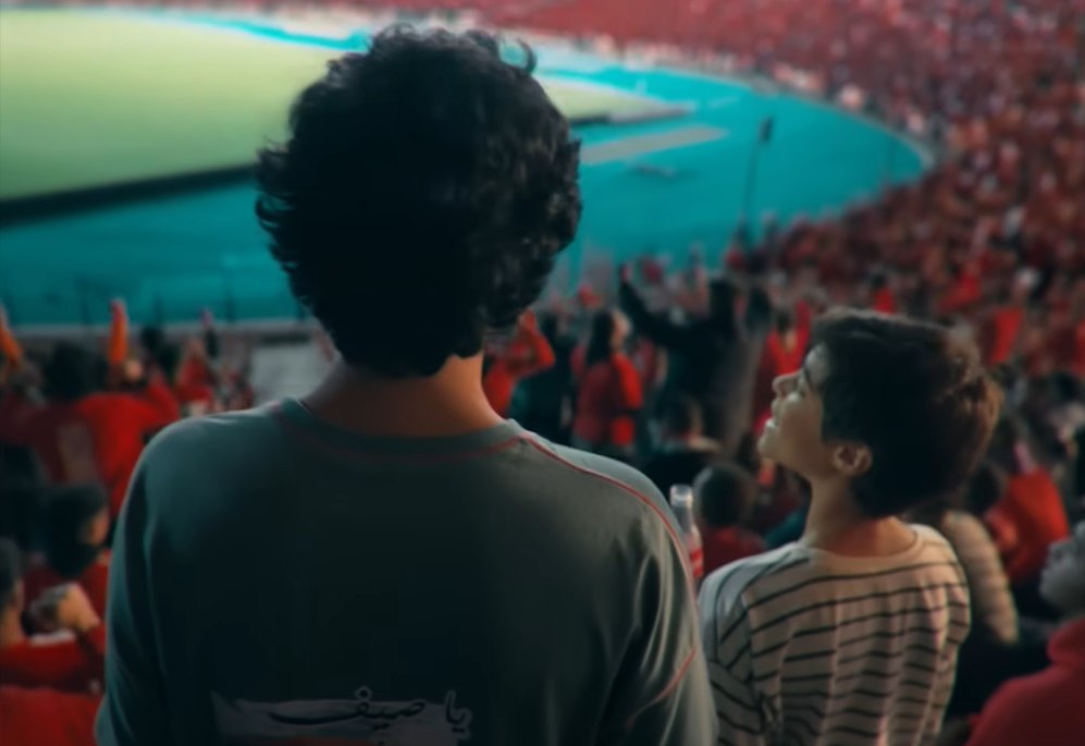 Final film frame — the packed stadium stands