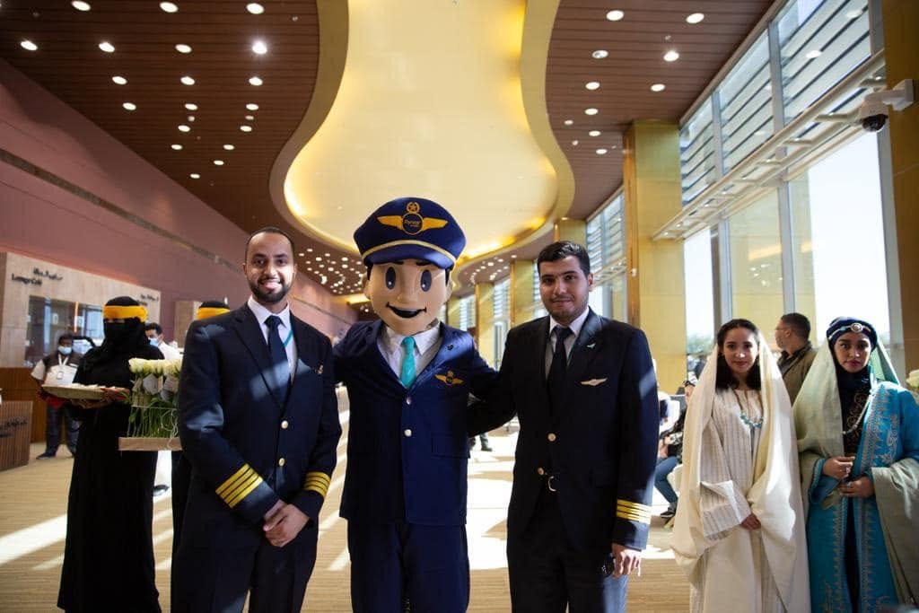 Captain Firnas mascot with flynas pilots at a brand event