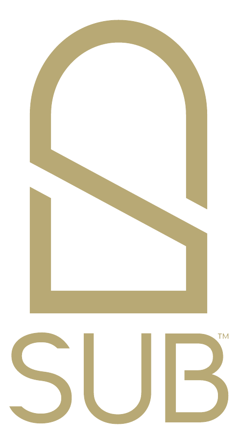 The SUB brand mark — an arch monogram built from the letters S, U and B — in gold above the SUB wordmark, on a warm charcoal ground